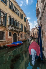 Fototapeta na wymiar Shrouded boat in a Venetian canal