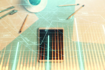 Double exposure of forex graph on digital tablet laying on table background. Concept of market analysis