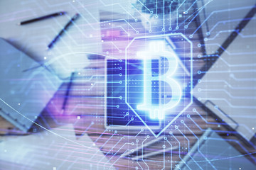 Double exposure of bitcoin drawing on digital tablet on the table background. Concept of blockchain