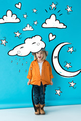 excited kid in silver hat, jeans and orange shirt on blue background with stars, moon, clouds and rain fairy illustration