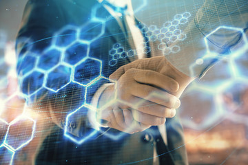 Double exposure of abstract technology drawing on cityscape background with two businessmen handshake. Concept of tech role in business