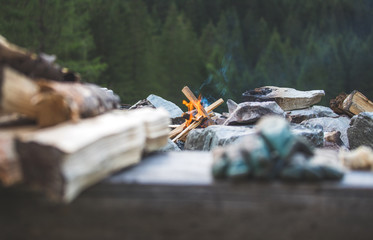 Making a bonfire: Small flame on a camping trip, adventure outdoors