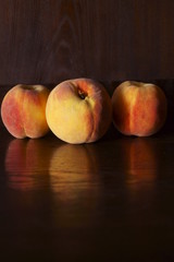 Fresh peaches on a dark background 