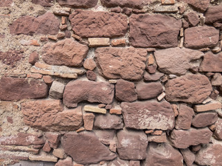 Old wall made of big and small stones . Vintage rough blocks surface background