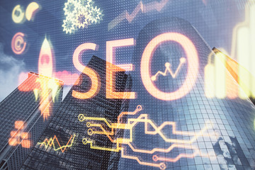SEO hologram on city view with skyscrapers background double exposure. Search optimization concept.