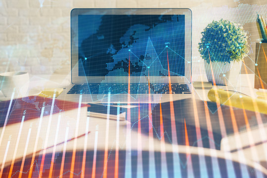 Financial graph colorful drawing and table with computer on background. Double exposure. Concept of international markets.