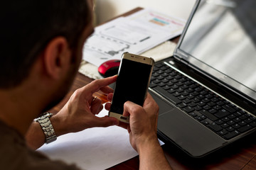 Working on preparing an English class, with the computer, blank paper to write down and some exercises.