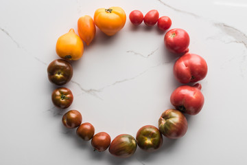 flat lay with colorful tomatoes in circle with empty space in middle