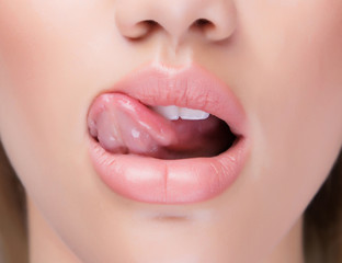 Close up juicy lips with tongue licking it. - obrazy, fototapety, plakaty