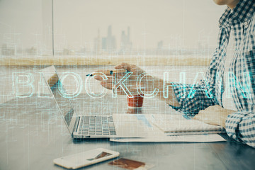 Blockchain theme hud with man working on computer on background. Concept of crypto chain. Double...