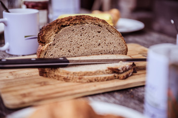 Rustic breakfast on an alpine hut: fresh crisp bread and milk in glass bottle, outdoors