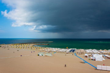 Famous beach and stormy sky at Faleza Nord coast in Constanta , Romania.
