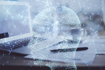 Double exposure of desktop with computer and brain drawing hologram. Artificial intelligence...