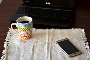 Morning coffee, with the computer and cell phone - Powered by Adobe
