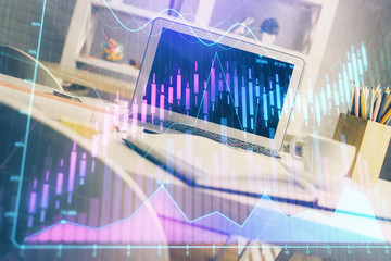 Financial chart drawing and table with computer on background. Double exposure. Concept of international markets.