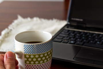 Computer with a cup of coffee.