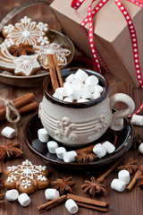 Hot cocoa with marshmallows and gingerbread cookies on the wooden background. Christmas concept