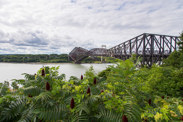 Fototapeta premium Beautiful view of the 1919 steel Quebec Bridge and the 1970 Pierre Laporte bridge over the St. Lawrence river seen from the Ste. Foy sector of the north shore, Quebec City, Quebec, Canada
