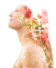 Double exposure profile of a natural beauty with lush orange flowers which seemingly grow from her...