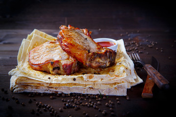 Roast pork loin and pita. Grill dishes, kebab and pita for the restaurant menu. Wooden background.