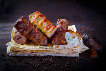 Lula kebab, onion sauce and pita. Grill dishes, kebab and pita for the restaurant menu. Wooden background.
