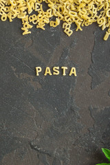 Pasta Alphabet and ingredient for sauce (set of ingredients, raw pasta) serving second course. top food background. copy space