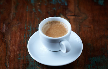 Cup of coffee on rustic wooden background. Copy space.