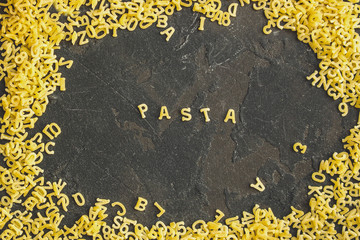 Fototapeta na wymiar Pasta Alphabet and ingredient for sauce (set of ingredients, raw pasta) serving second course. top food background. copy space