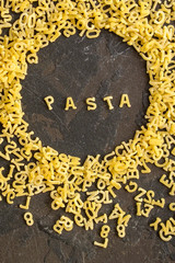 Pasta Alphabet and ingredient for sauce (set of ingredients, raw pasta) serving second course. top food background. copy space