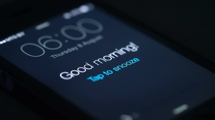 Good morning alarm clock on the phone in the dark room, detailed
