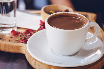 Traditional Turkish Coffee cup and Turkish delight concept with wooden background