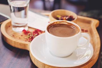 Traditional Turkish Coffee cup and Turkish delight concept with wooden background