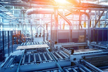 Production line of the wooden floor factory. CNC automatic woodworking machine.