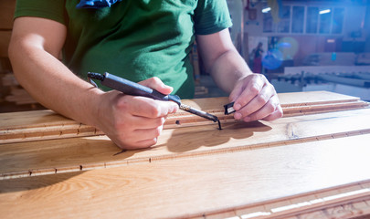 Carpenter with fibreboards at furniture factory workshop. Woodworking industry