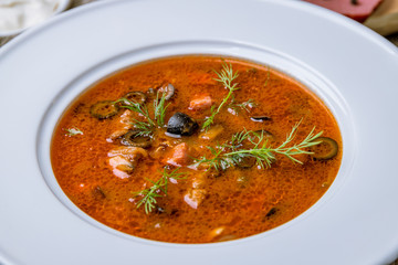 Meat Solyanka soup on wooden table