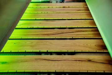 Production line of the wooden floor factory. CNC automatic woodworking machine.