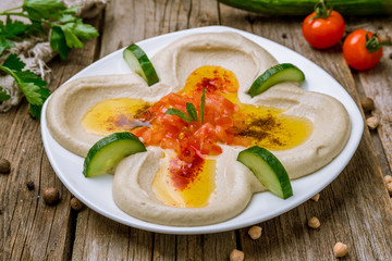 Traditional homemade hummus on wooden table, turkish cuisine.