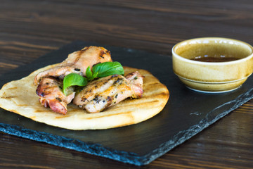 grilled chicken steak. meat on pita bread