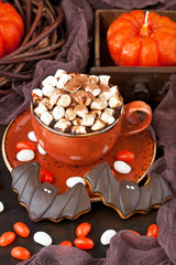 Halloween  time composition with cookies and hot chocolate mug