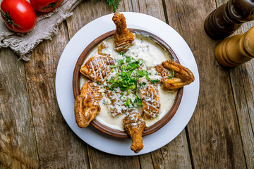 chicken chkmeruli in Georgian on wooden table