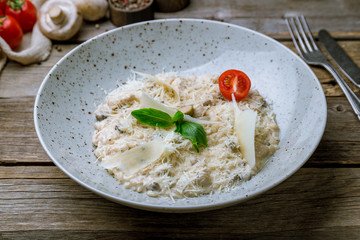 risotto with porcini mushrooms on old wooden table