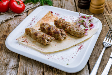 Lamb Lula kebab on wooden table