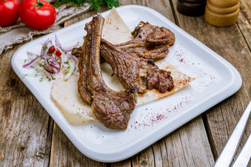 Rack of lamb on wooden table
