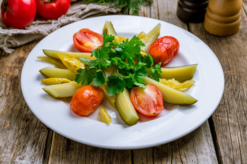 plate of pickles on wooden table
