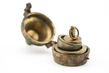 Antique set of weights patina brass on white background