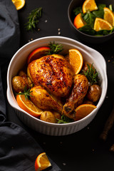 Roasted chicken with oranges ,rosemary and potato. Top view