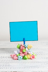 Reminder pile colored crumpled paper clothespin reminder white wooden space