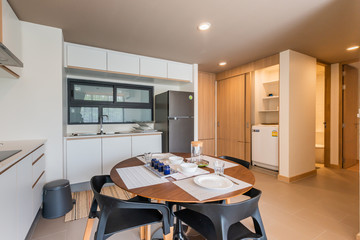 Stylish kitchen interior with dining table and chairs