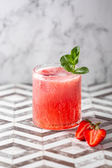 Fresh strawberry cocktail. Fresh summer cocktail with strawberry and ice cubes. Stawberry lemonade with leaves of mint.