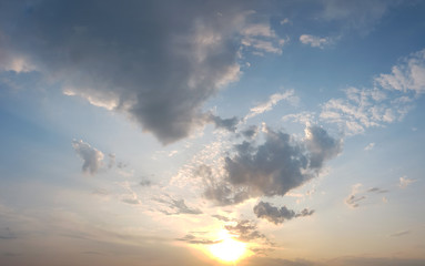 Naklejka na ściany i meble Cloudy sky in a sunset rays abstract background.